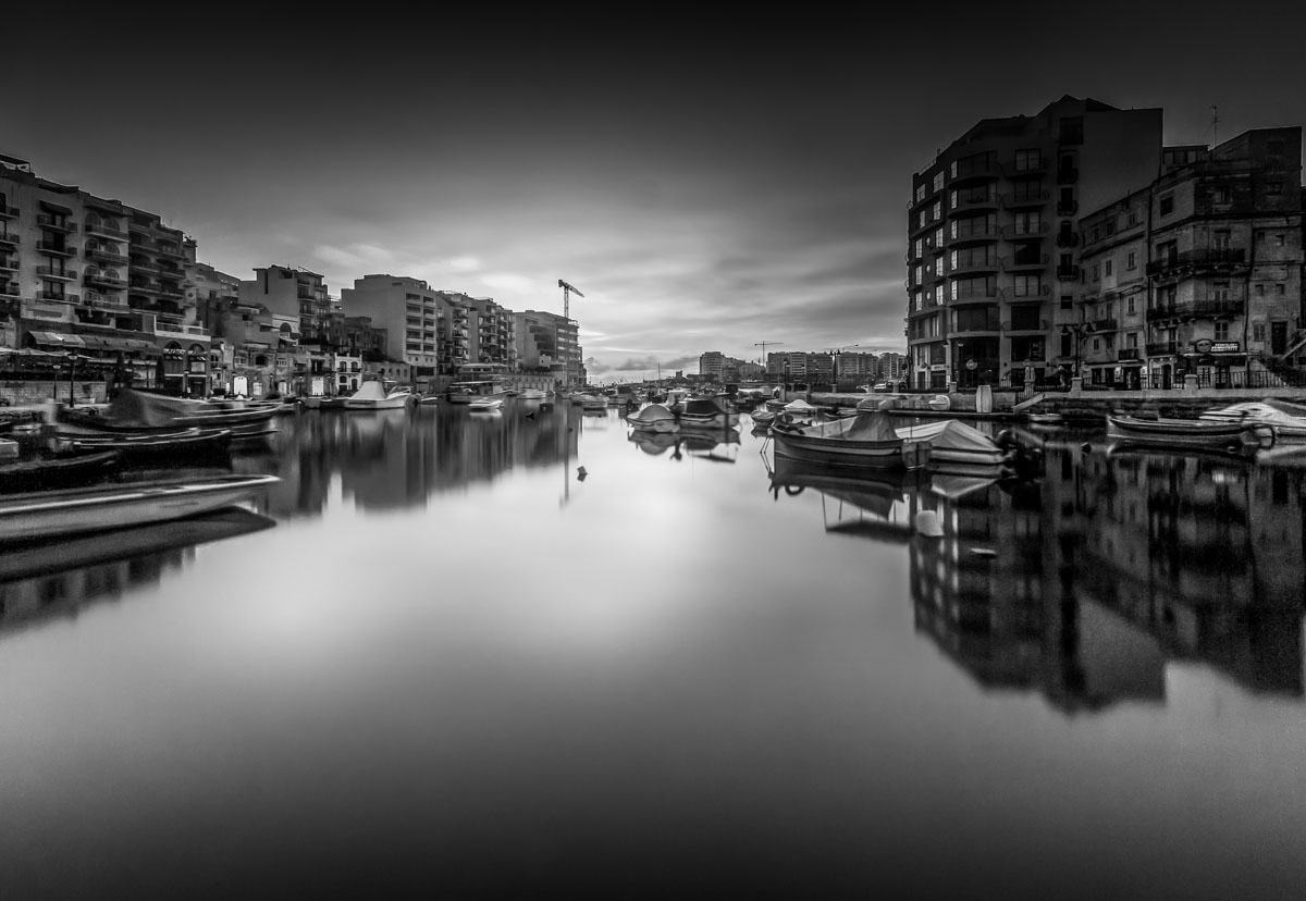 Malta black and white landscape reflection water bay city Malta buildings