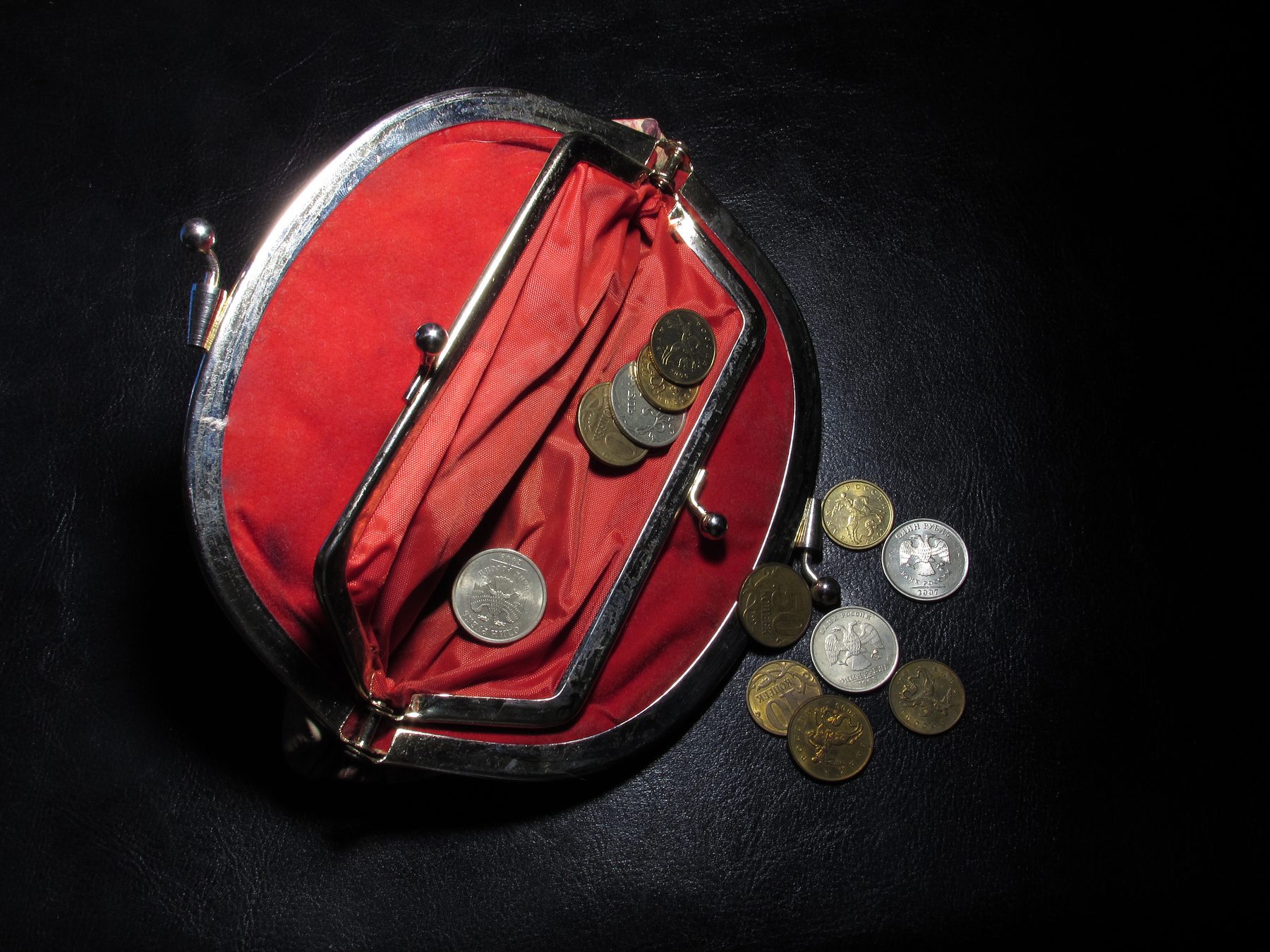 Red wallet with money on a black leather background antique art background black closeup coins color concept crisis currency design equipment fashion finance gold isolated light luxury metal money object old poverty red retro shiny sport style symbol vintage wallet wealth white