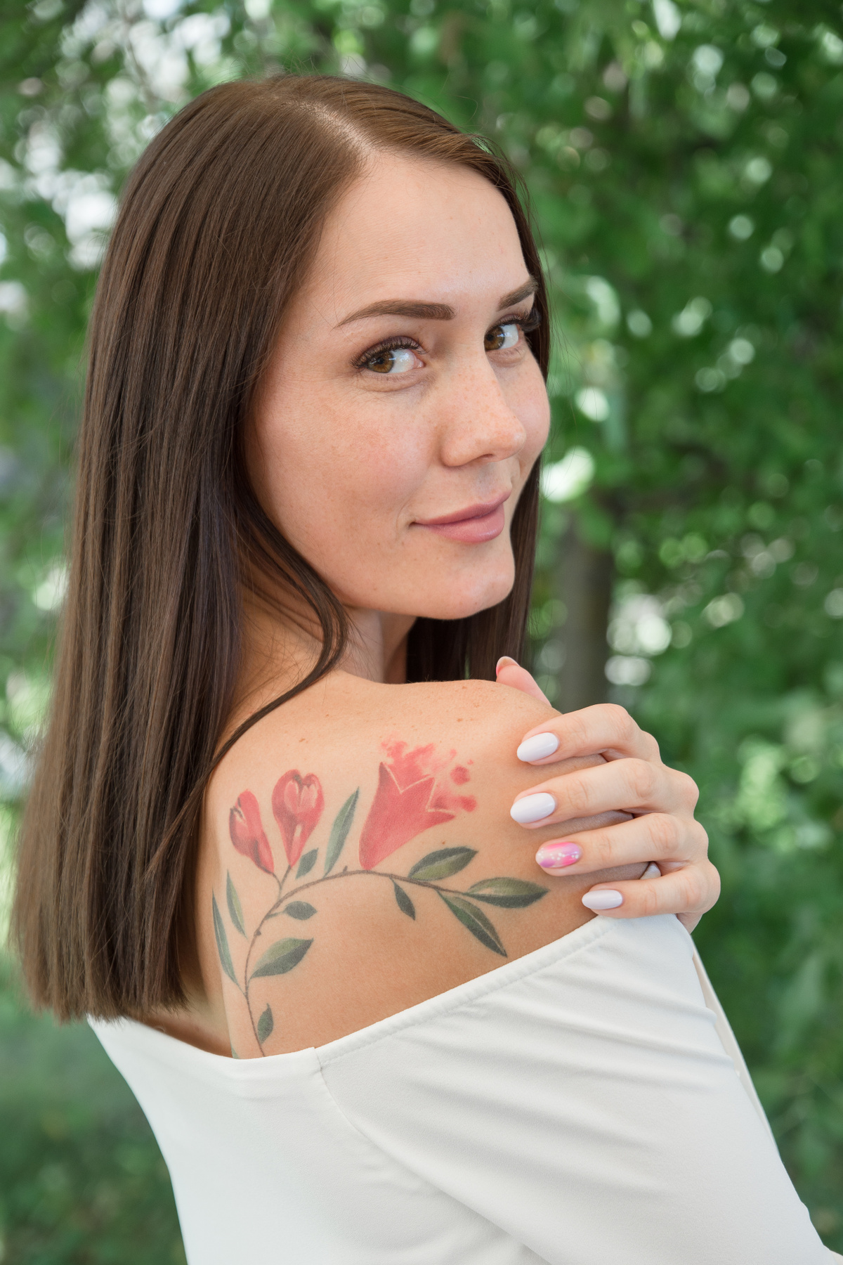 Девушка с татуировкой цветка 